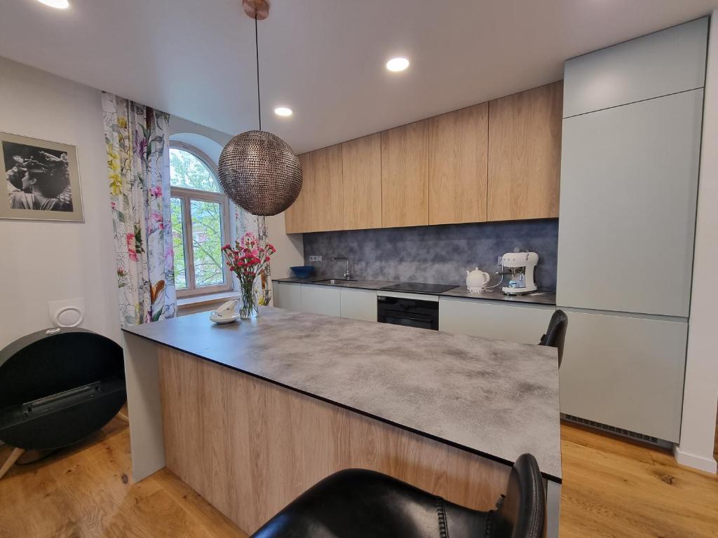 Kitchen island with stone countertop and pendant light