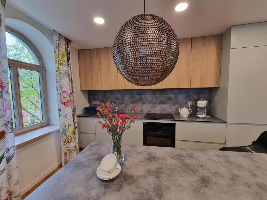 Kitchen with designer chandelier and floral curtains