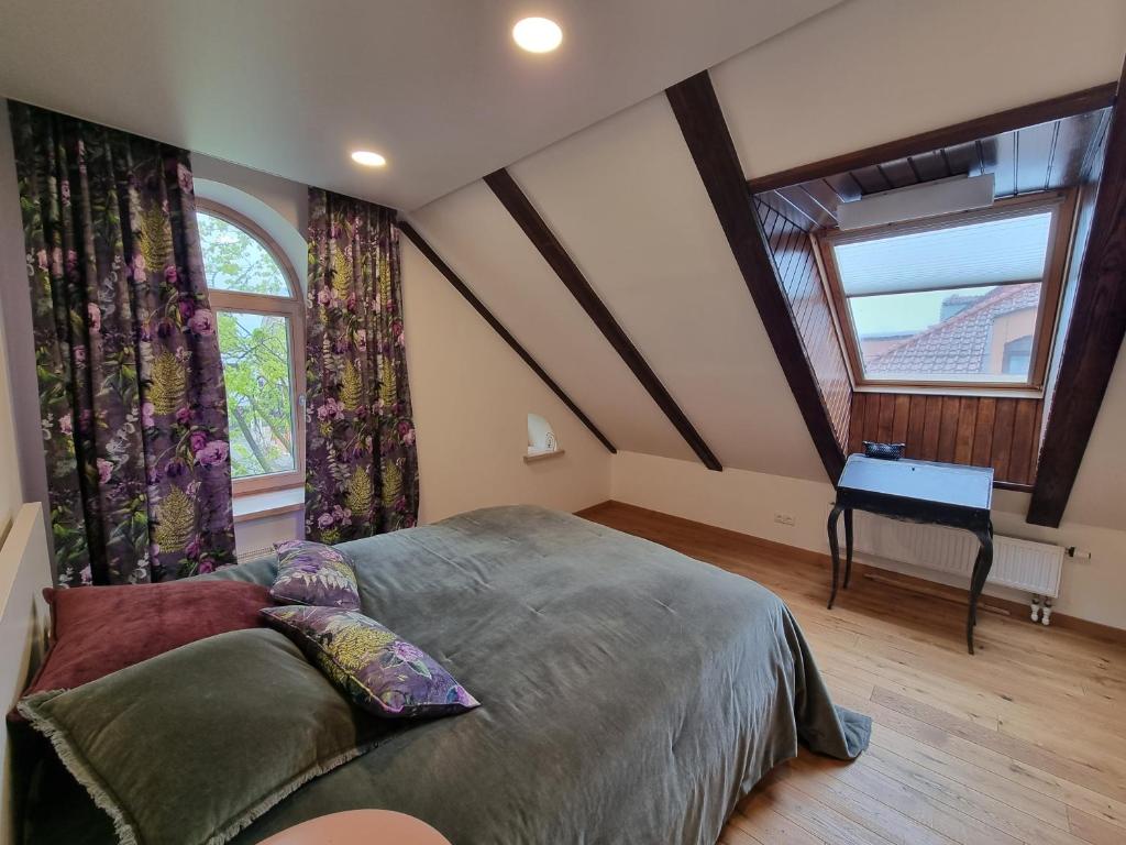 Bedroom with skylights and floral curtains