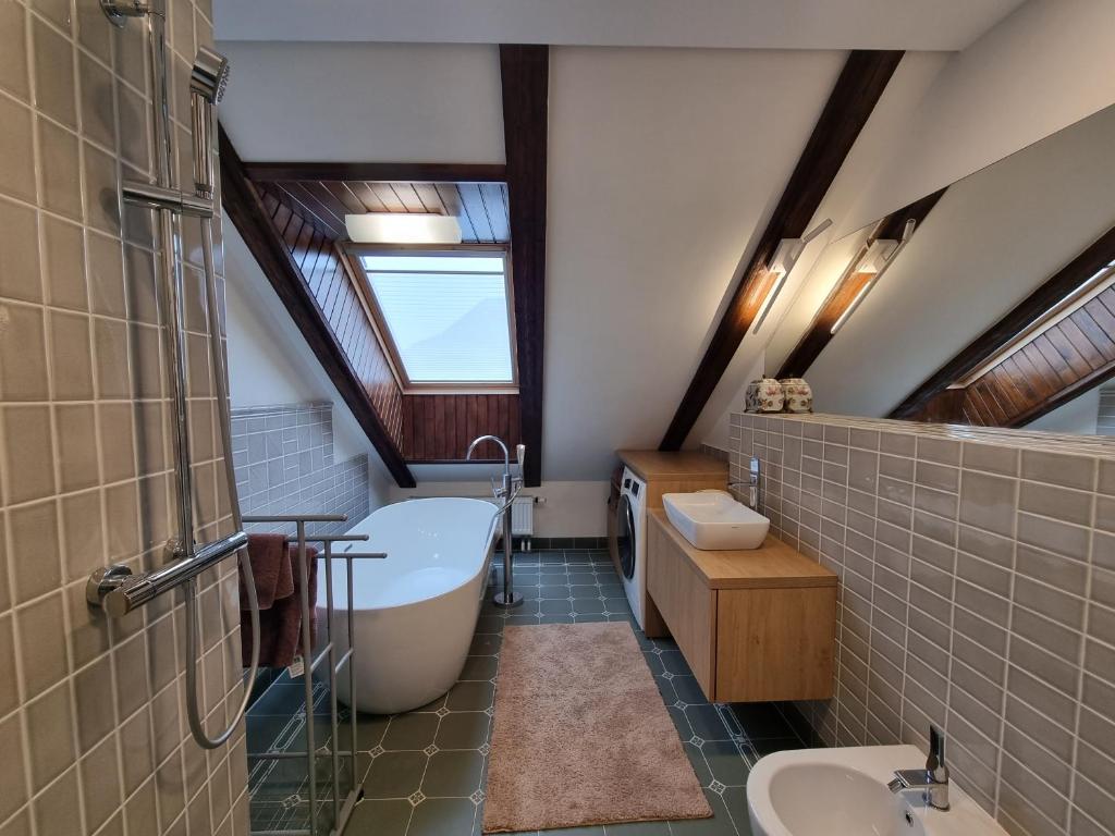 Bathroom with freestanding bathtub and skylight
