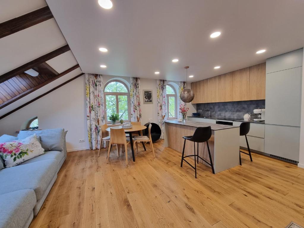 Open-plan living room and kitchen with exposed beams